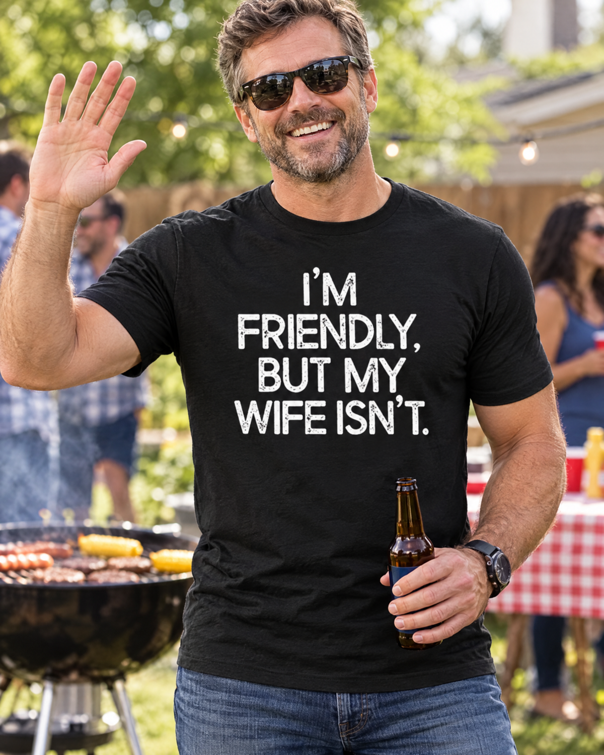 Man wearing the I'm Friendly But My Wife Isn't funny graphic tee at a backyard barbecue