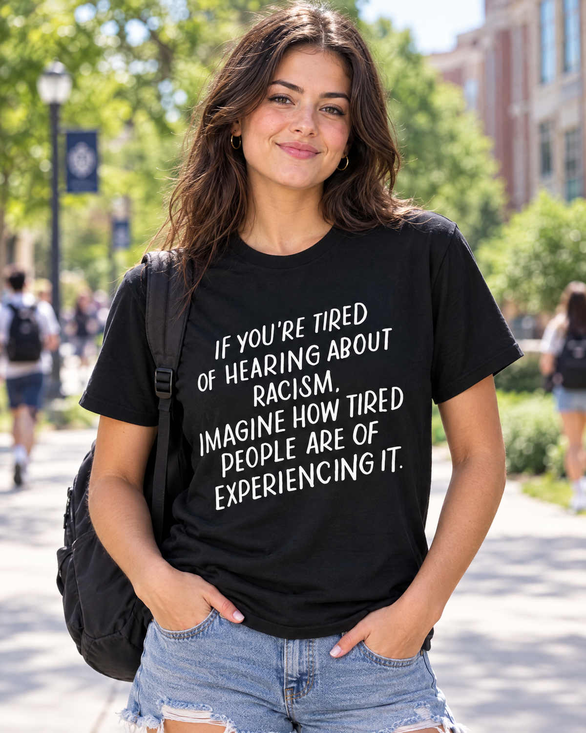 Woman wearing the anti racism graphic tee on a college campus