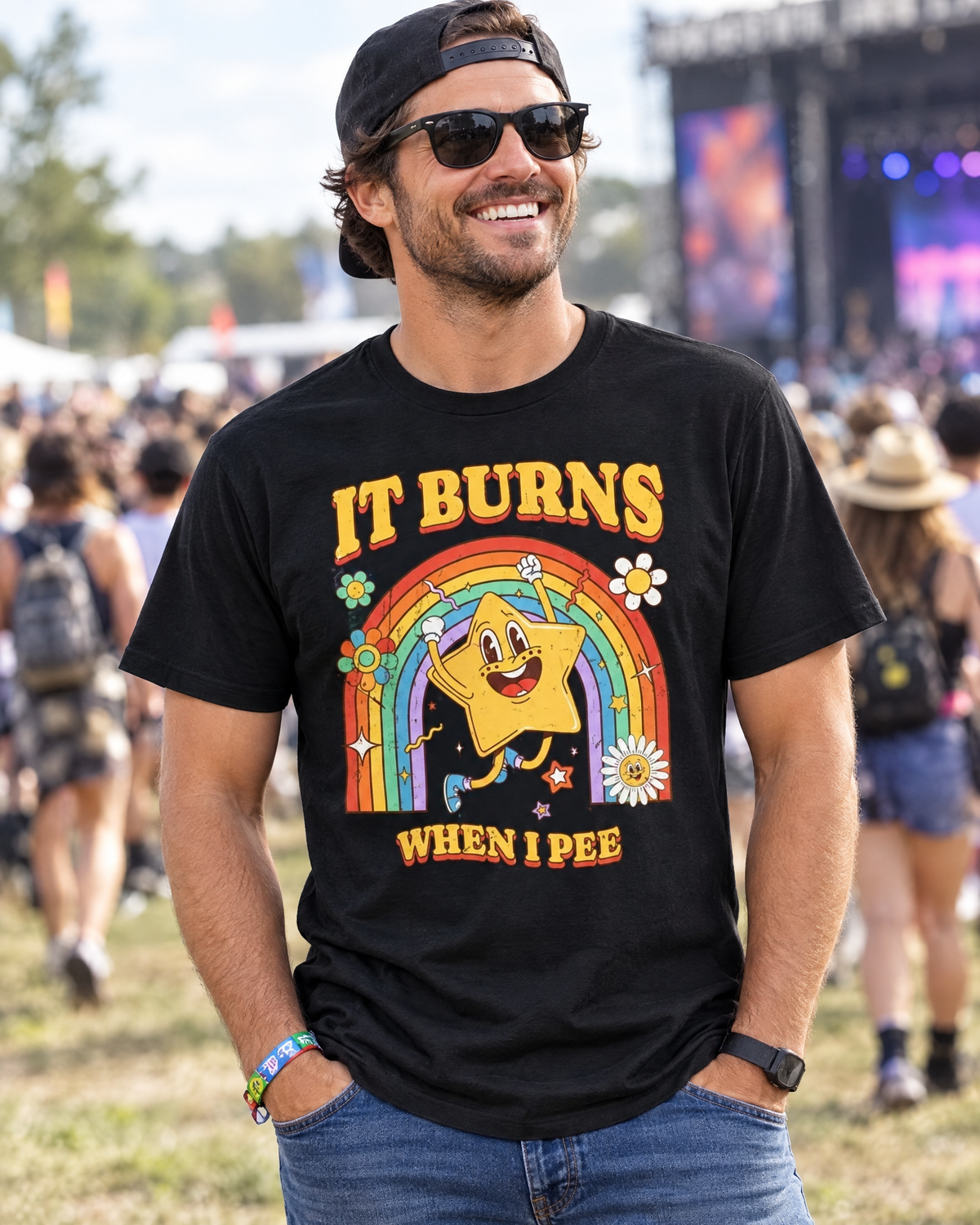 Man wearing the It Burns When I Pee funny graphic tee at an outdoor festival