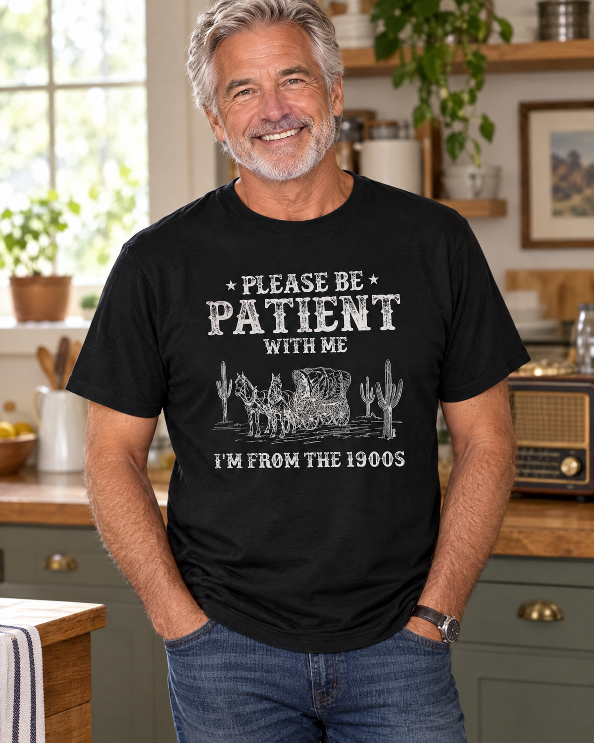 Older man wearing the Please Be Patient With Me, I'm From The 1900s funny graphic tee in a kitchen