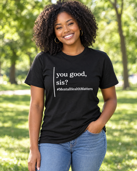 Woman wearing the You Good, Sis? mental health matters graphic tee in a park